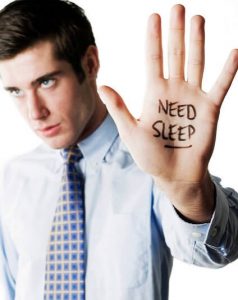 Foods That Help You Sleep -- photo of man with "need sleep written on his hand