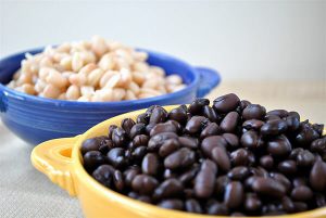 health benefits of potassium -- photo of bowls filled with blck and white beans