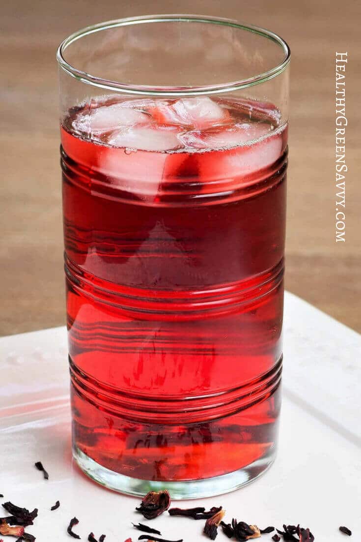 photo of brewed hibiscus tea in glass with ice
