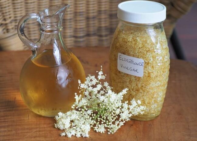 photo of elderflower cyme with elderflower vinegar on table