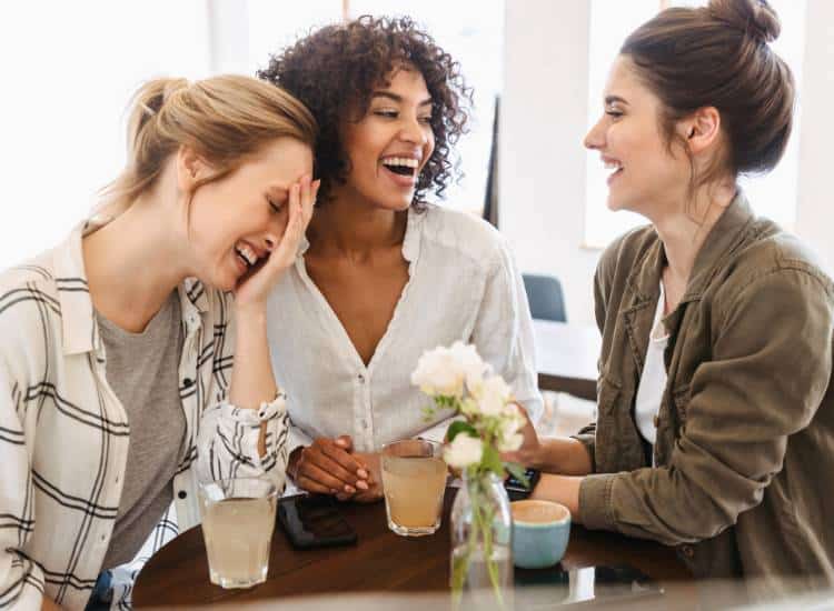 photo of women at cafe laughing