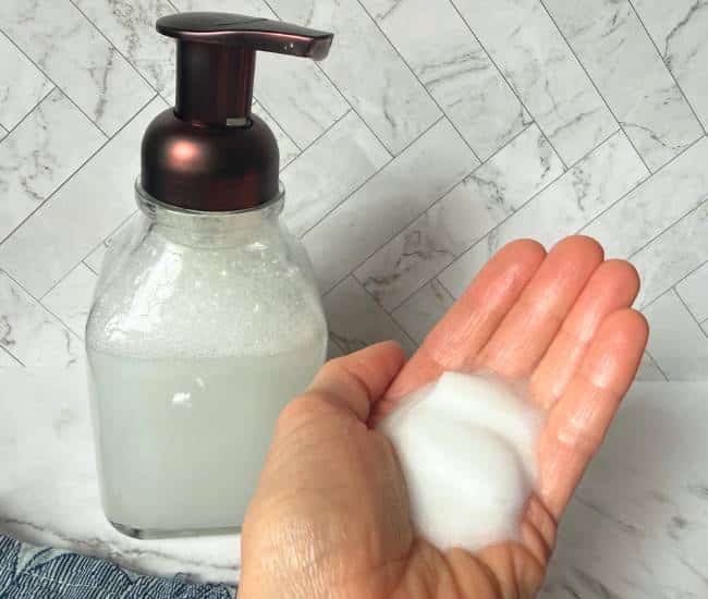 photo of DIY foaming hand soap in bottle and on hand