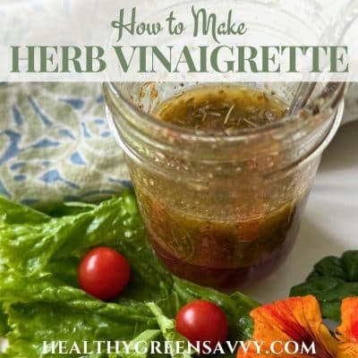 cover photo of herb vinaigrette recipe in jar surrounded with lettuce and nasturtiums plus title text overlay